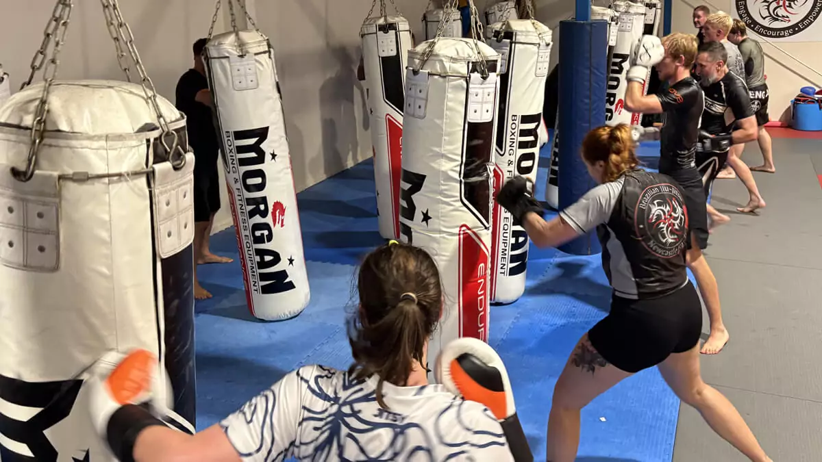 Group kickboxing session at Newcastle Karate dojo with punching bags