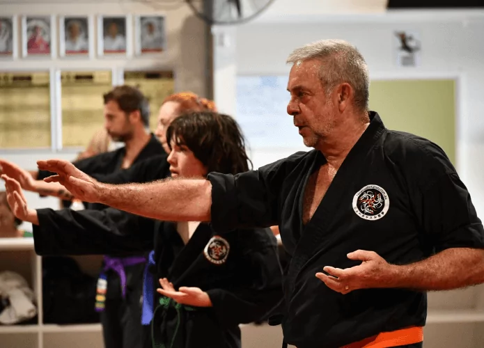 Adult karate students practising traditional karate striking techniques in dojo training